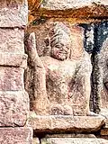 An image of a male figure displaying his penis with his legs raised.