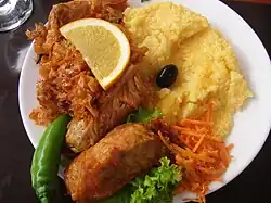 Image 22A popular Moldovan dish of sarmale (stuffed cabbage rolls), accompanied by sauerkraut and mămăligă (from Moldovan cuisine)