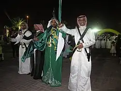 Image 6Saudi males dressed and prepared for ardah, the national dance. It also includes swords, poetry, and singing. (from Culture of Saudi Arabia)