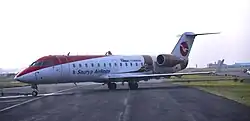 A Saurya Airlines Bombardier CRJ200 facing left on a taxiway