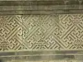 A wall with both left- and right-facing, rotated 45° swastikas on a building in China.