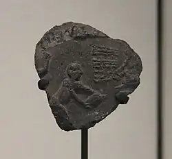 Clay bulla with sealing impression representing a scene of grain storage. From Susa, Louvre Museum.