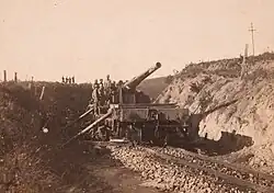 Cannon in a trench, with soldiers aboard for scale