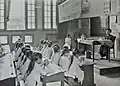 Tailoring class in a colonial school in Hanoi, Tonkin