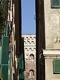 A glimpse among the narrow buildings of the historic center. Note the presence of louvers, a type of frame that is very common in Liguria.