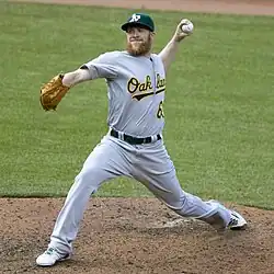 Sean Doolittle throwing a pitch in a gray Oakland Athletics uniform