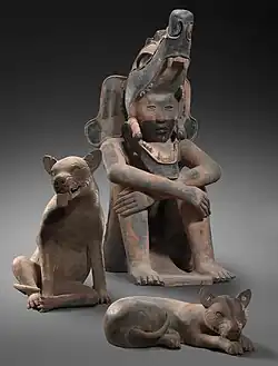 Sculptures of a seated warrior and two dogs, 400–800 CE