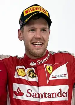 Sebastian Vettel cheering on the podium after winning the 2015 Malaysian Grand Prix for Ferrari.