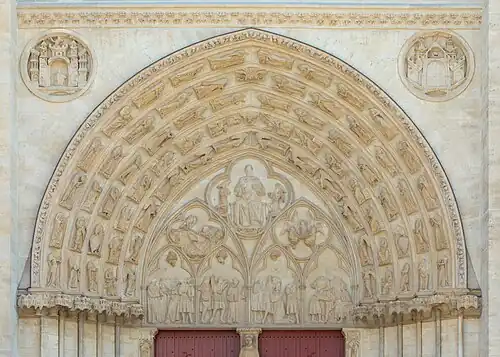 Tympanum of the life of Saint Stephen. The heads of most figures were knocked off during the French Revolution