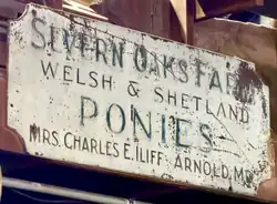 Original "Severn Oaks Farm" sign stored inside a farm barn