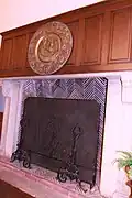 Shakespeare in relief above the auditorium fireplace.