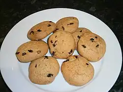 a plate of golden brown biscuits, studded with raisins