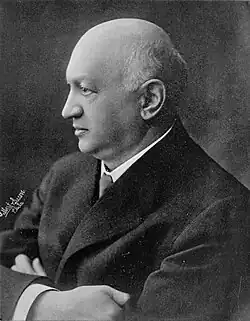 Side portrait of Siegmund Lubin in a suit with his arms crossed