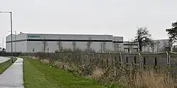 A selection of grey buildings at least two-storeys high, with Siemens branding on the left hand side