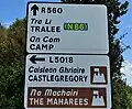 Irish road sign using special character forms for A, a, i, and capitals M and N, for Irish text