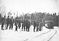 Skiers waiting for the streetcar, Rockliffe Park, c1913