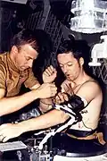 Weitz assists Kerwin with a blood pressure cuff.