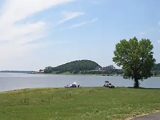 Wide body of water viewed from a green sloping bank