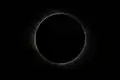 Totality in Jiuquan, China. Red prominences are visible on both sides of the Sun