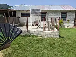 A makeshift power station in Cuba, consisting of a lead-acid battery, a solar panel, and a controller