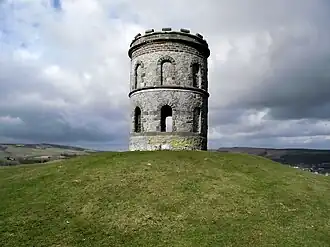 Stone tower on grass-covered hilltop