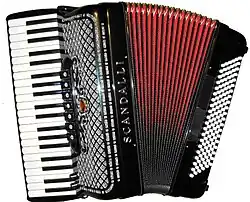 A picture of a red and black button accordion