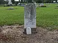 Confederate grave stone at cemetery with Southern Cross of Honor symbol displayed at top
