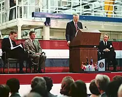NASA Administrator address the crowd at the Spacelab arrival ceremony in February 1982. On the podium with him is then-Vice President George Bush, the director general of European Space Agency (ESA), Eric Quistgaard, and director of Kennedy Space Center Richard G. Smith