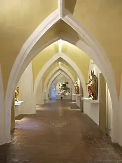 Gothic vault in the exhibition "City of Arts" with Gothic and Baroque sculptures.