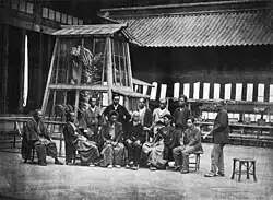 Directors of the exposition, before the golden shachi in the Taiseiden courtyard (1872)