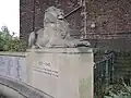 Right lion pedestal and inscription