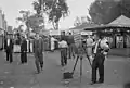 A photographer selling portrait photos in 1937