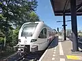 An Arriva Stadler GTW waiting on the platform.