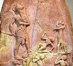 Victory Stele of Naram-Sin, c. 2230 BC. It shows him defeating the Lullibi, a tribe in the Zagros Mountains, and their king Satuni, trampling them and spearing them. Satuni, standing right, is imploring Naram-Sin to save him.[61] Naram-Sin is also twice the size of his soldiers.