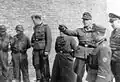 Jürgen Stroop, the senior SS and police officer of the district, escorted by German soldiers and policemen, during Warsaw Ghetto Uprising
