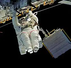Astronaut Linda M. Godwin translates along the longeron of Atlantis' cargo bay starboard side during EVA 1.