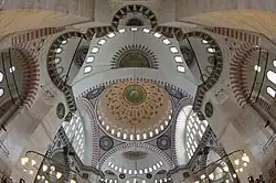 The Süleymaniye Mosque (1550–7), evokes the Hagia Sophia's design with a central dome and two semi-domes.[102]