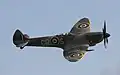 Supermarine Spitfire with 20&nbsp;mm cannon protruding from the leading edge of the wing