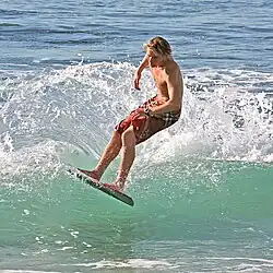 A surfer surfing a wave in California