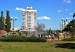 In the centre of town, with 16-floor one (left) and house with a clock (right) in sight.