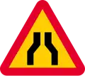 Road narrows on both sides