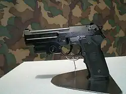 A T75K1 pistol with a laser sight attached.