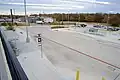 View of bus stops and parking lot from rail platform.
