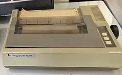 A beige, Texas Instruments-branded dot matrix printer with its lid closed.