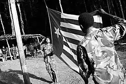 Image 9West Papuan separatists raising the Morning-Star flag in the jungles of Papua, 1971 (from Western New Guinea)