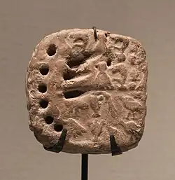 Numerical tablet with two types of numerical signs and the impression of two cylinder seals. Susa, ca. 3800-3100 BC. Louvre Museum.