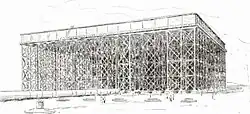black and white drawing of a square tank, not very deep compared to its very large area, elevated high on trestles, with a pipe on the ground larger than the people in the foreground