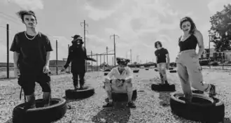 Tallah in 2022, left to right: Max Portnoy, former member Alizé "Mewzen" Rodriguez, Justin Bonitz, Derrick Schneider, and Alex Snowden.