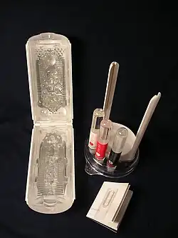 Flip Hole White split open, showing its complex internal structure. The user's manual and lotions are also shown