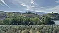 Terraced vineyards near Régua are scattered across the rolling hills, reflecting the river.